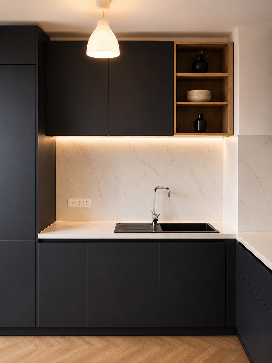 Vue frontale de l’évier et des rangements noirs